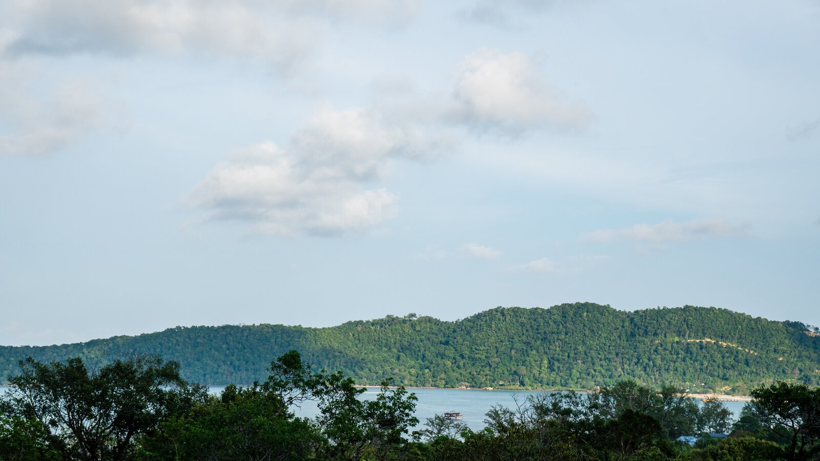 Panoramic view from the Hillside rooms looking out over lush green treetops and ocean at Island Center Point hotel, Koh Rong Sanloem.