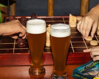 Golden craft beer placed while playing Ouk Chaktrang at Island Center Point hotel, Koh Rong Sanloem.