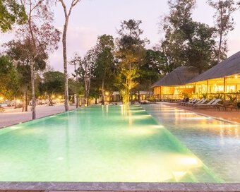 Softly illuminated swimming pool in the evening at Island Center Point, Koh Rong Sanloem.