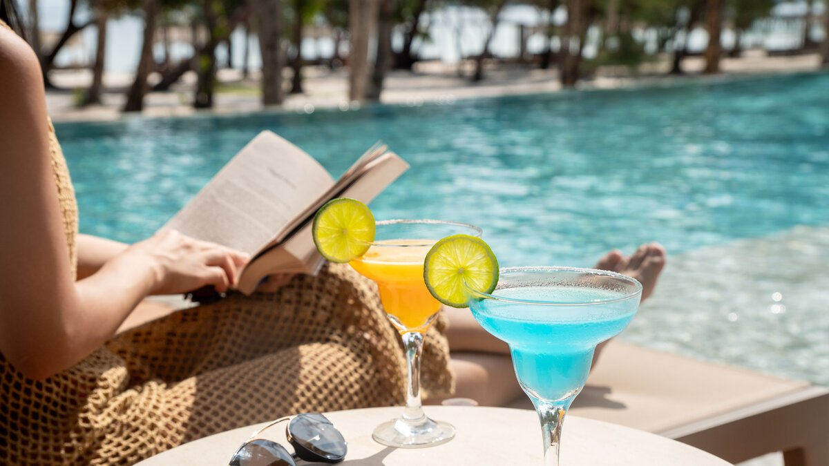 Relaxing poolside with colorful cocktails, Green Season offer featuring 10% off food and beverage at Island Center Point hotel, Koh Rong Sanloem.