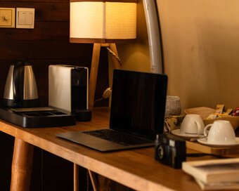 Wooden work desk inside the tented cabin room (Junglo)