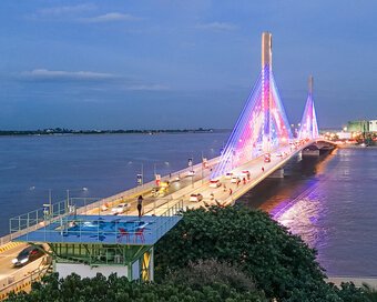 Water Tower's rooftop pool, overlooking the illuminated bridge crossing a wide river.