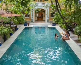 guests with drinks at Pavilion Hotel main pool, Phnom Penh