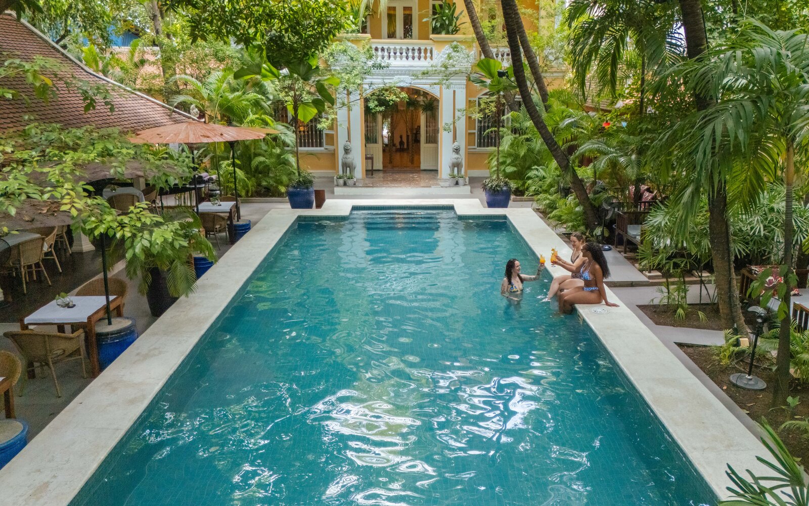 guests with drinks at Pavilion Hotel main pool, Phnom Penh