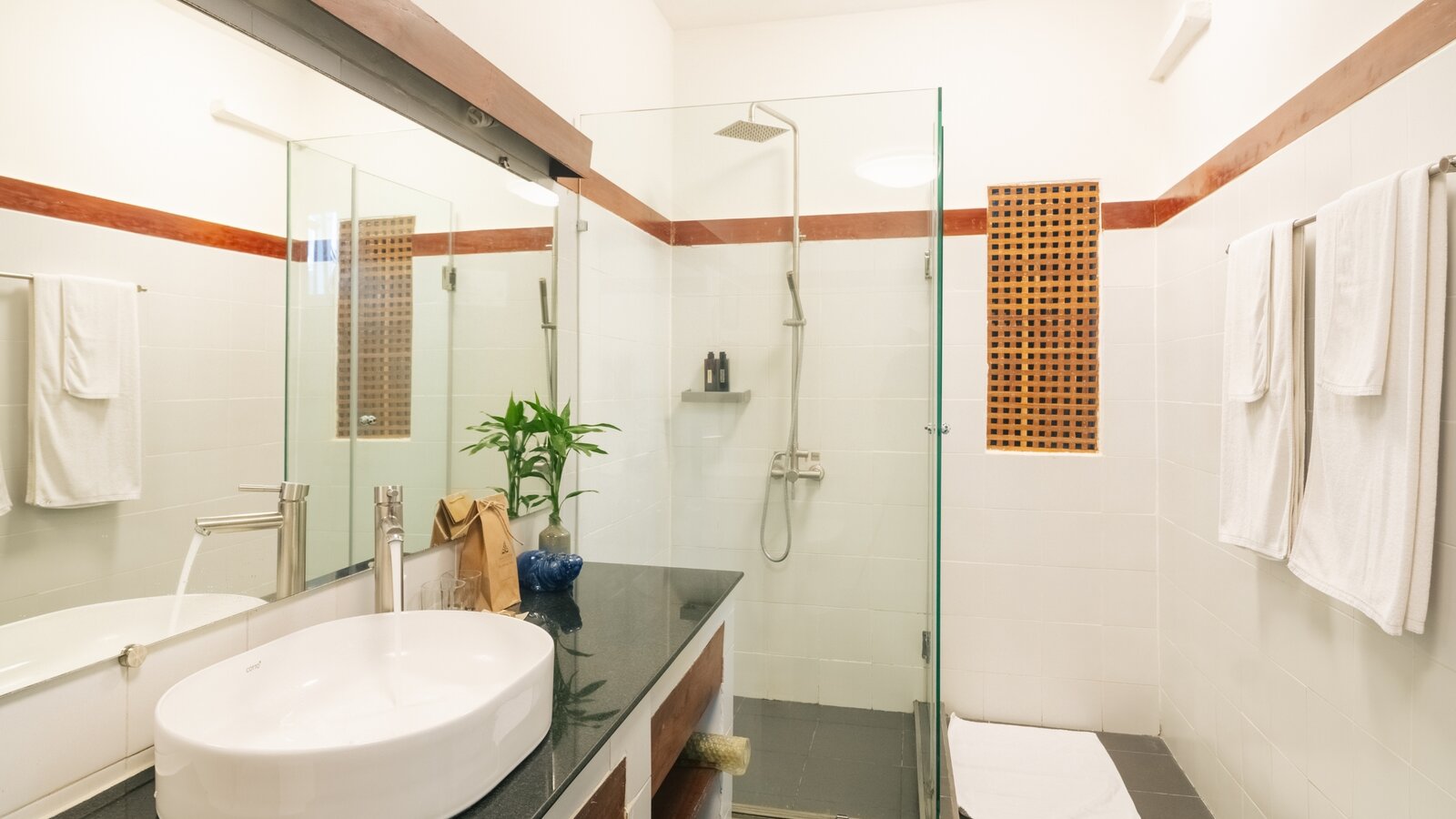 Bathroom with vanity, basin and walk-in shower in the Private Jacuzzi at Pavilion Phnom Penh