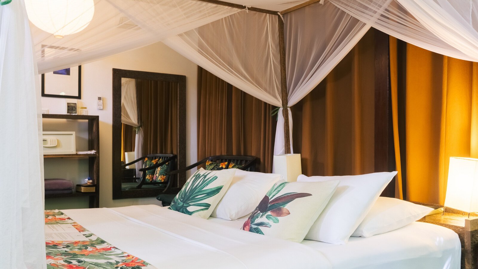 King bed with mosquito net and botanical cushions in the Private Jacuzzi bedroom