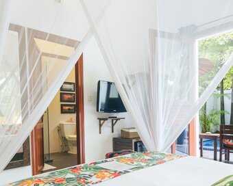 King size bedroom opening onto the private pool at Pavilion Phnom Penh.