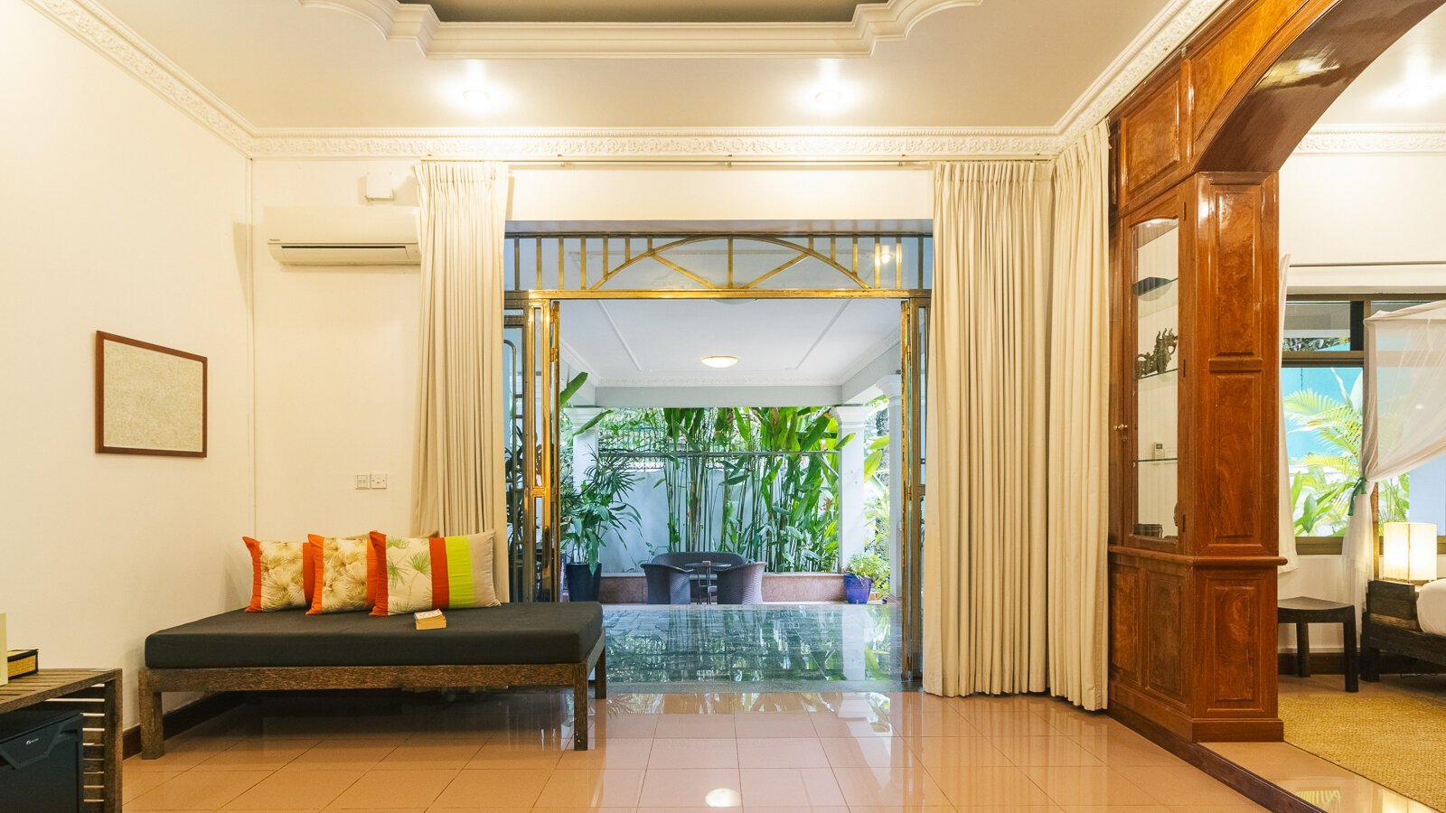 Spacious Pavilion suite living area opening onto a terrace surrounded by tropical plants