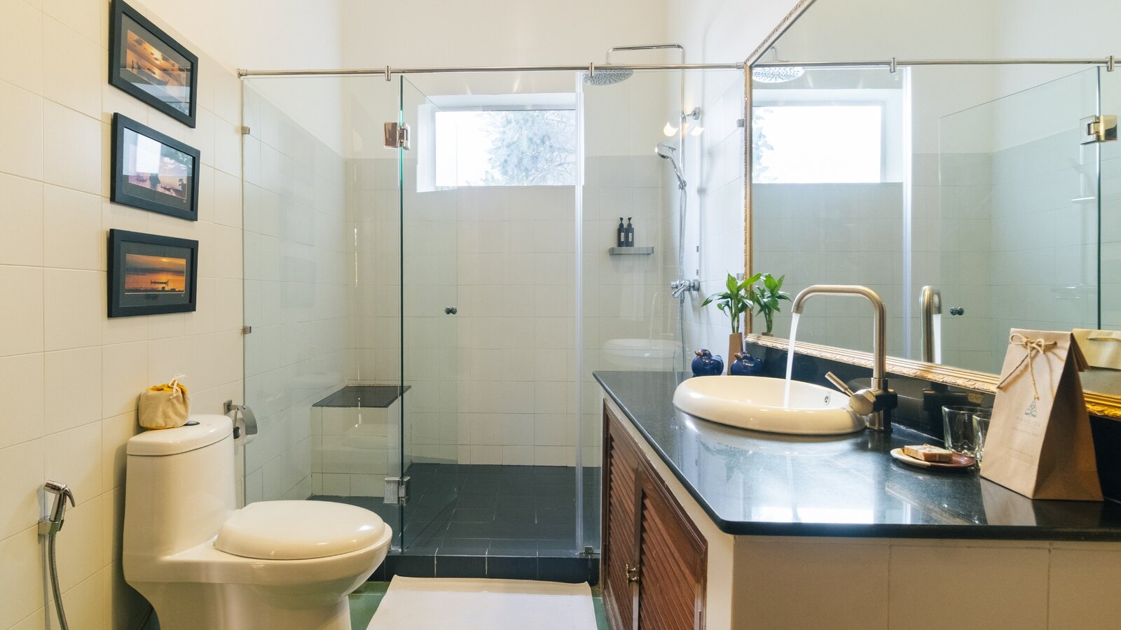 Pavilion suite bathroom with vanity, toilet and glass-enclosed walk-in shower in Phnom Penh