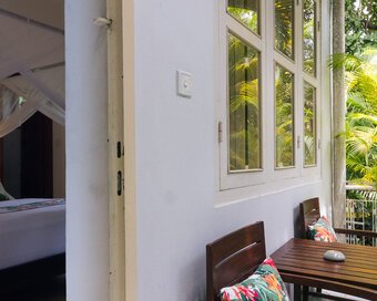 Outdoor seating beside the bedroom of a Superior Room at Pavilion Phnom Penh