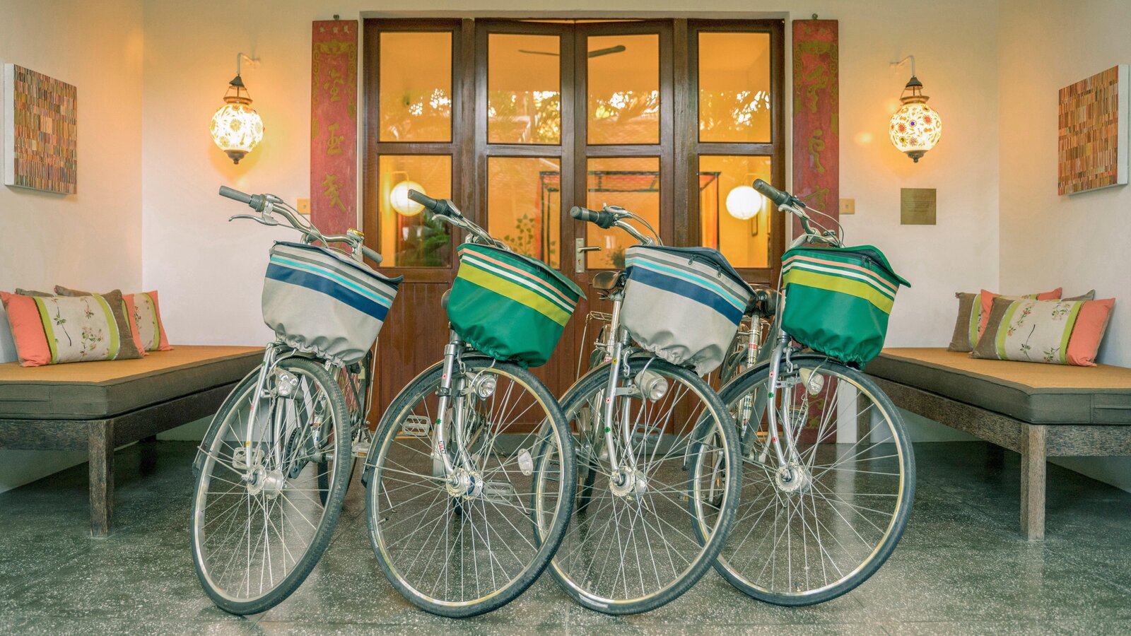 Four free bicycles arranged in front of Pavilion's building.