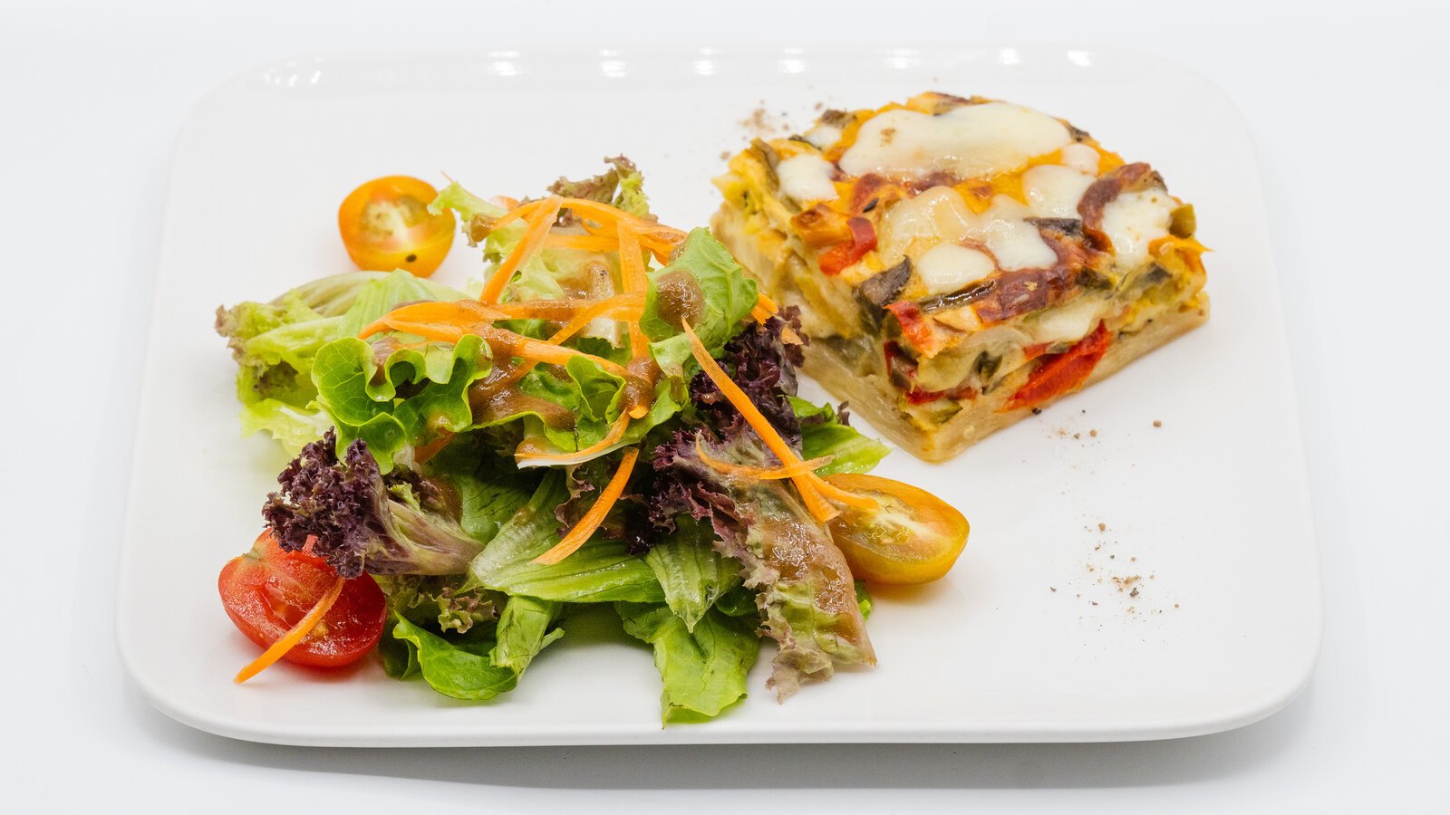 vegetarian quiche with mixed greens side.