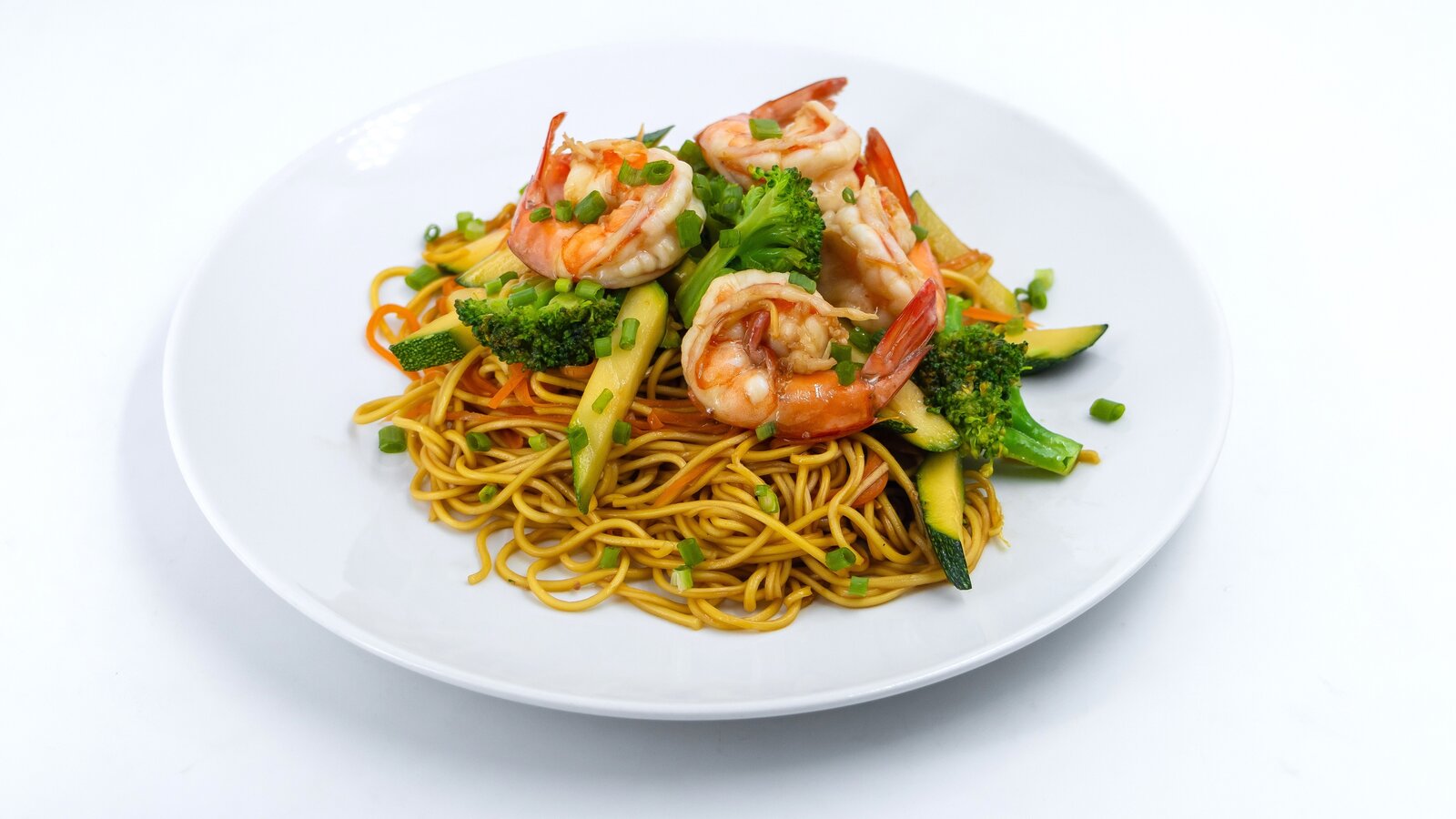 yellow noodles with shrimp and broccoli.