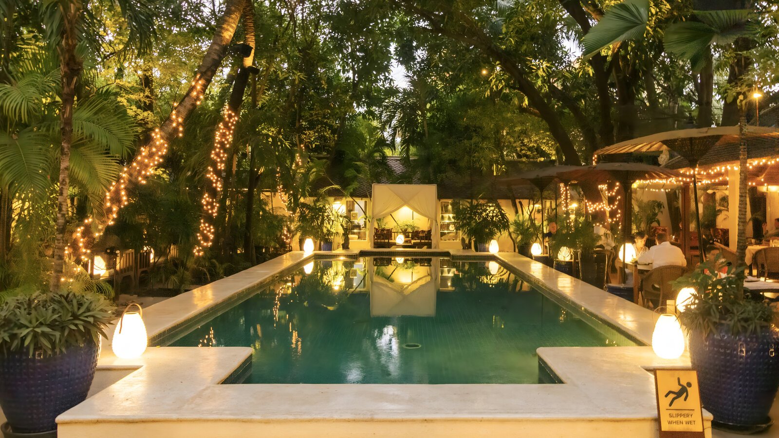 Evening soft lighting of Lush Pool with Cabana at Pavilion Hotel.