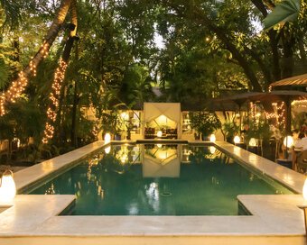 Evening soft lighting of Lush Pool with Cabana at Pavilion Hotel.