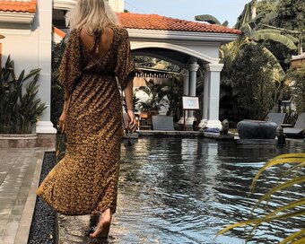 Guest walking barefoot along the edge of the Sun Pool, Pavilion Hotel.