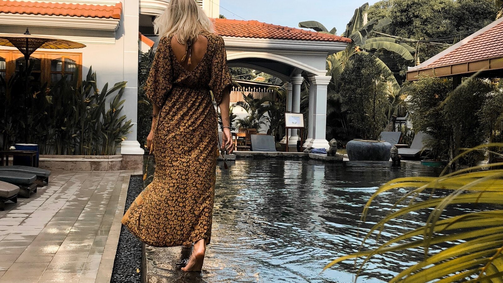 Guest walking barefoot along the edge of the Sun Pool, Pavilion Hotel.
