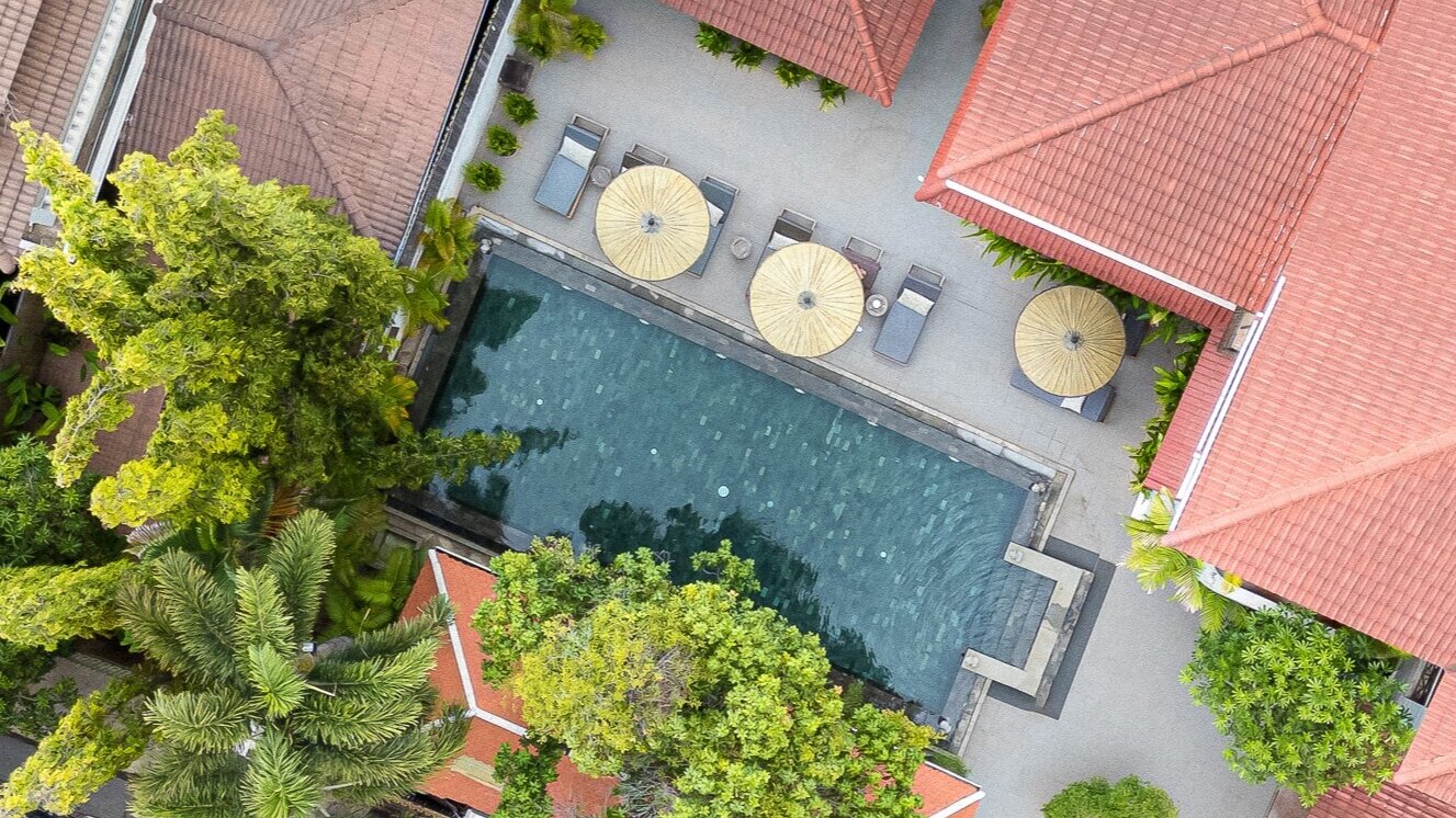 Top-down view of the Sun Pool with sun bed loungers and surrounding gardens.