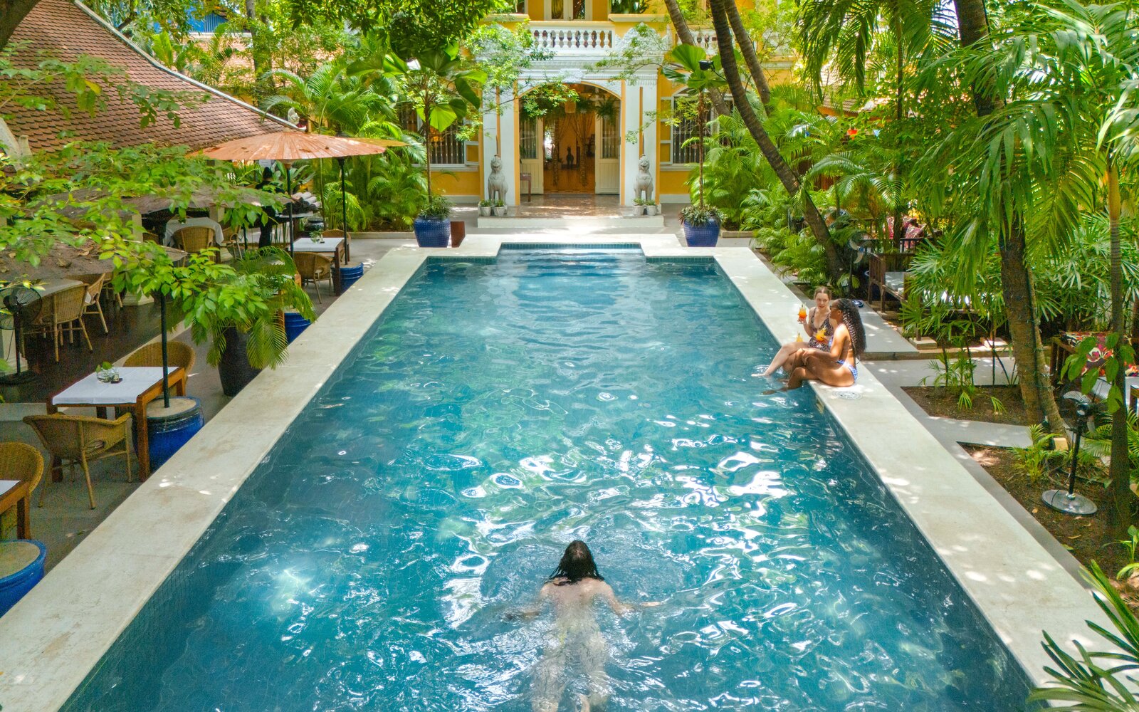 Main pool with swimmers at Pavilion Heritage Oasis Hotel, Phnom Penh