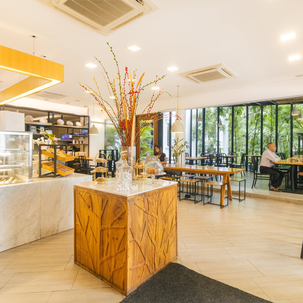 Open cafe layout and seating with garden view from Le Café, White Mansion Hotel, Phnom Penh.